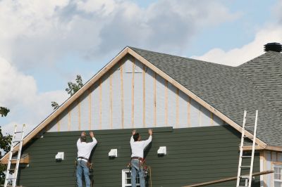 Fiber cement siding being applied